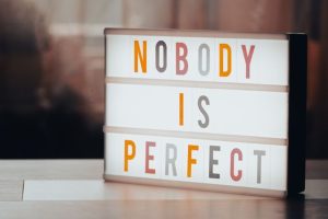 lettres sur un tableau écran avec écrit : nobody is perfect